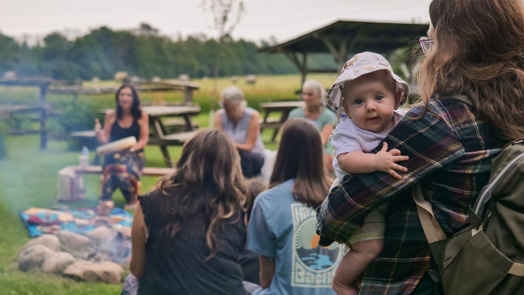 Herb Camp Gathering Baby in Arms