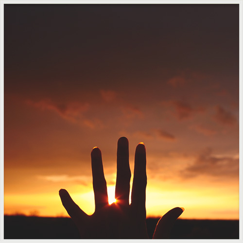 hand and sunset